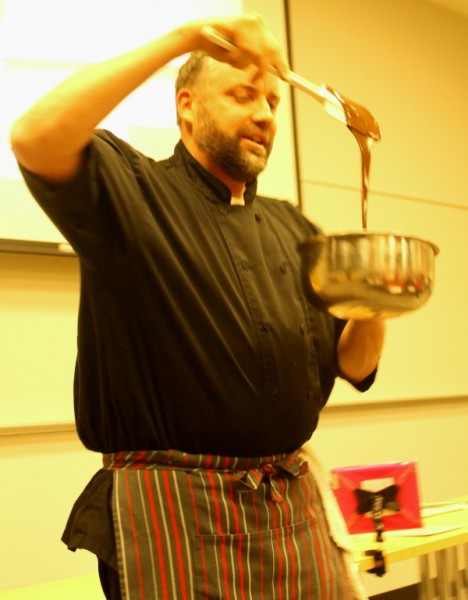 Yule log chef showing chocolate in bowl