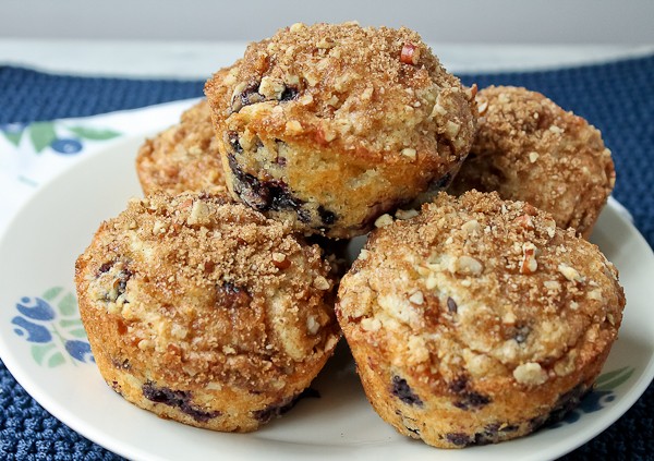 Blueberry muffins piled on plate