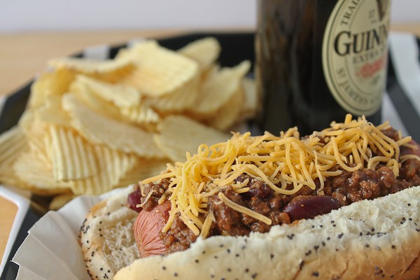 Chili dogs and chips with beer close up