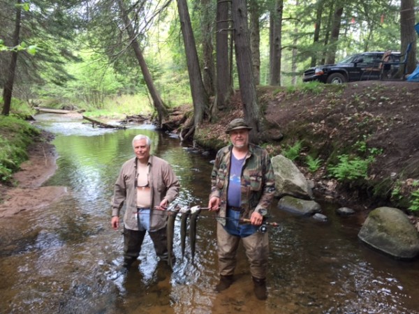 Bill & Benny in stream with fish